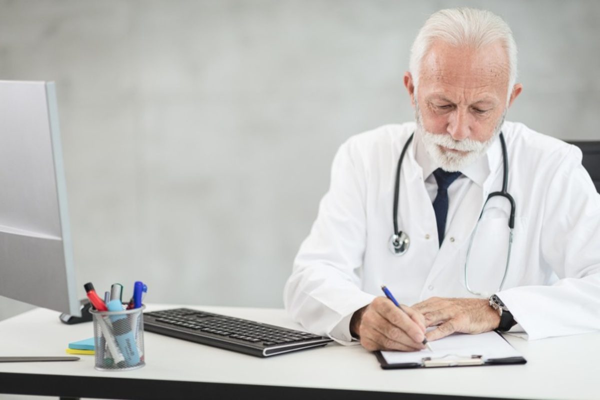 Professional reviewing compliance paperwork at a workstation