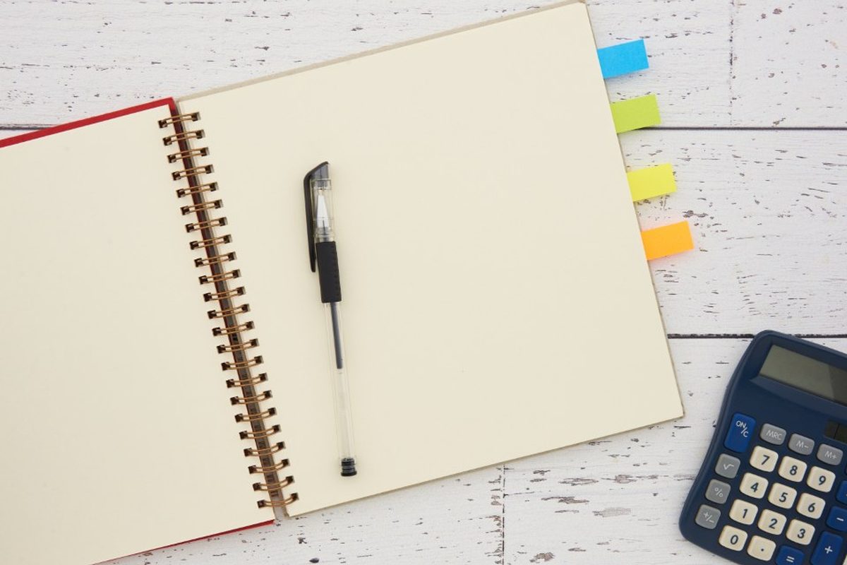 Bookkeeping notebook and calculator on a desk
